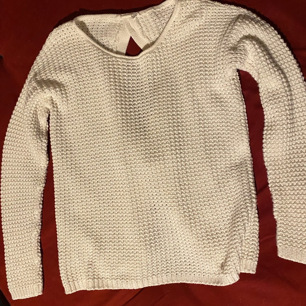 Cream colored sweater. Medium size. Three bows down the back.